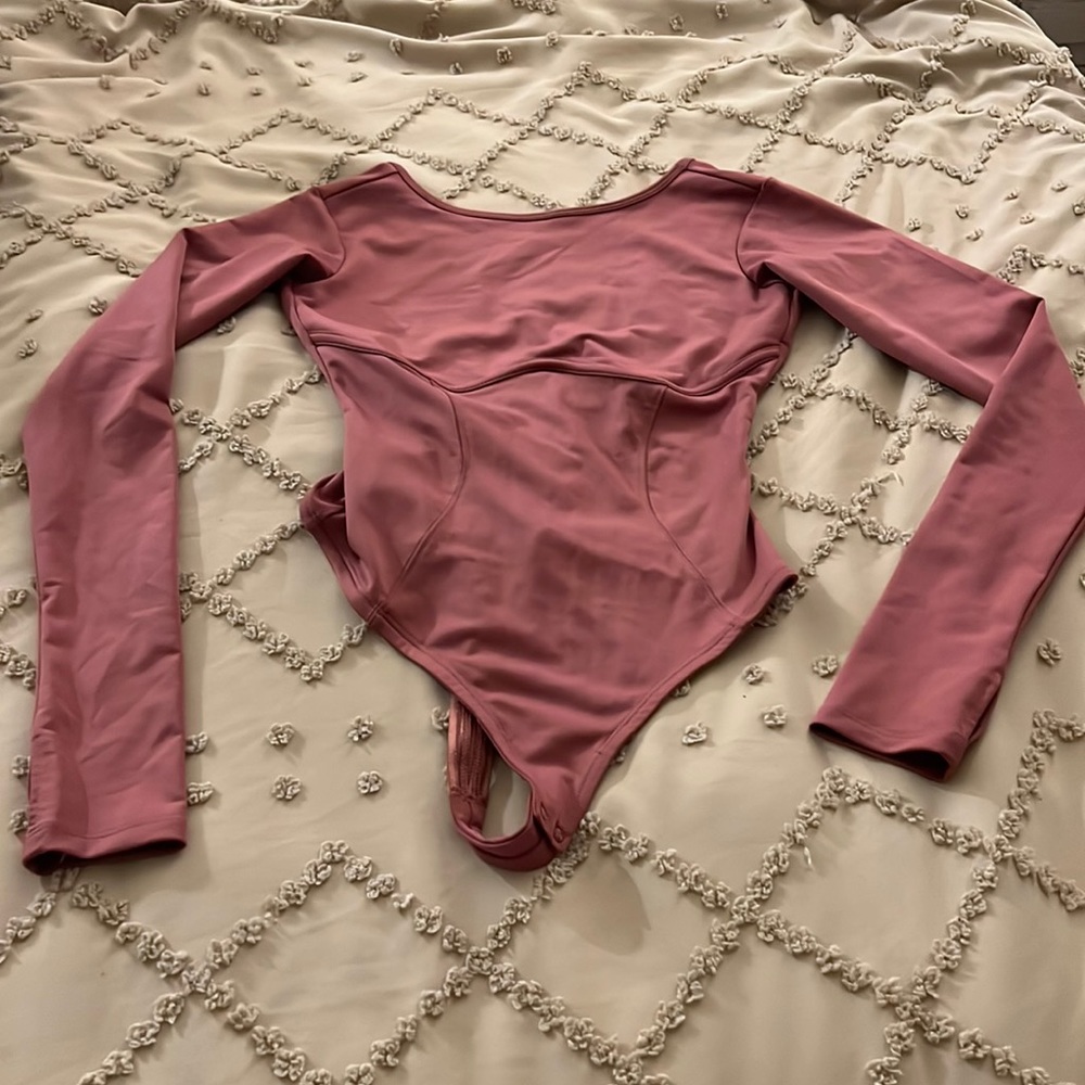 Fabletics pink, small thong bodysuit, never worn. Openings on sleeve for fingers